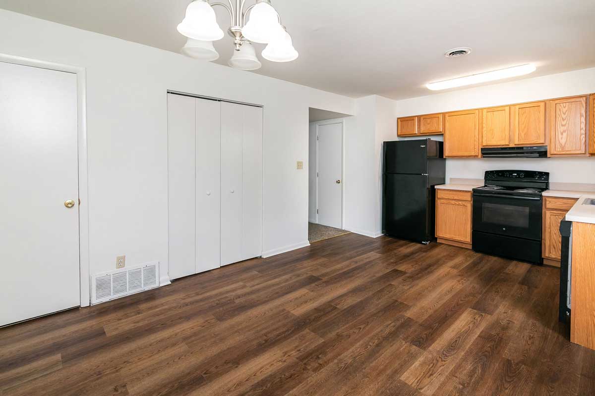 Hickory Hill Townhomes Kitchen view from opposite corner of last picture, showing laundry doors, utility closed, partial view of bathroom door, cabinets and appliances.