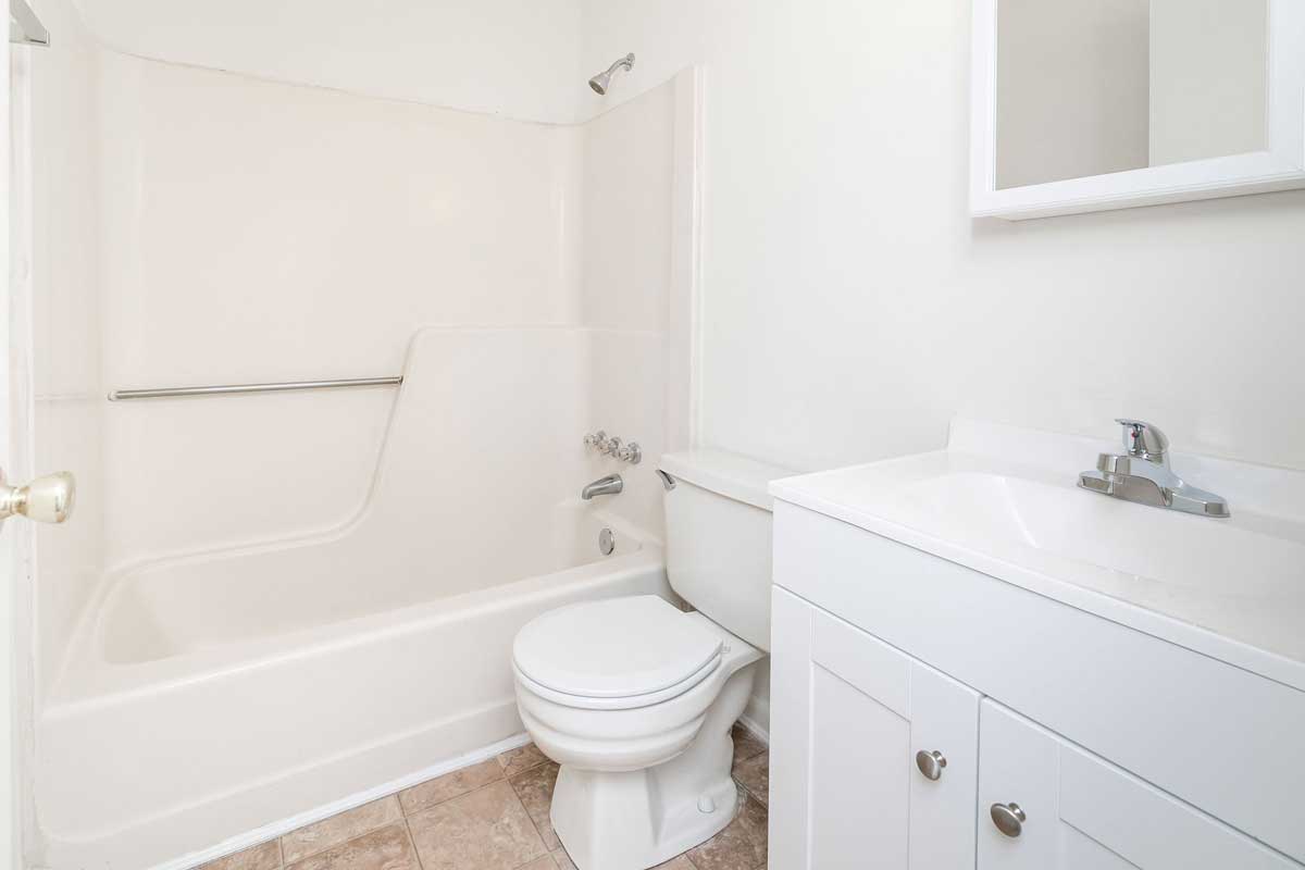 Hickory Hill townhouse 2nd floor bathroom, white tub/shower surround; white sink top and vanity cabinet