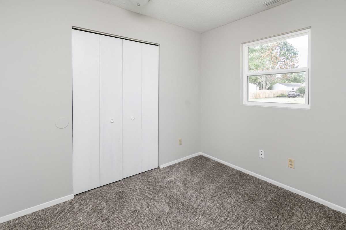 Township bedroom 1 , view of closet double bifold doors to closet and window