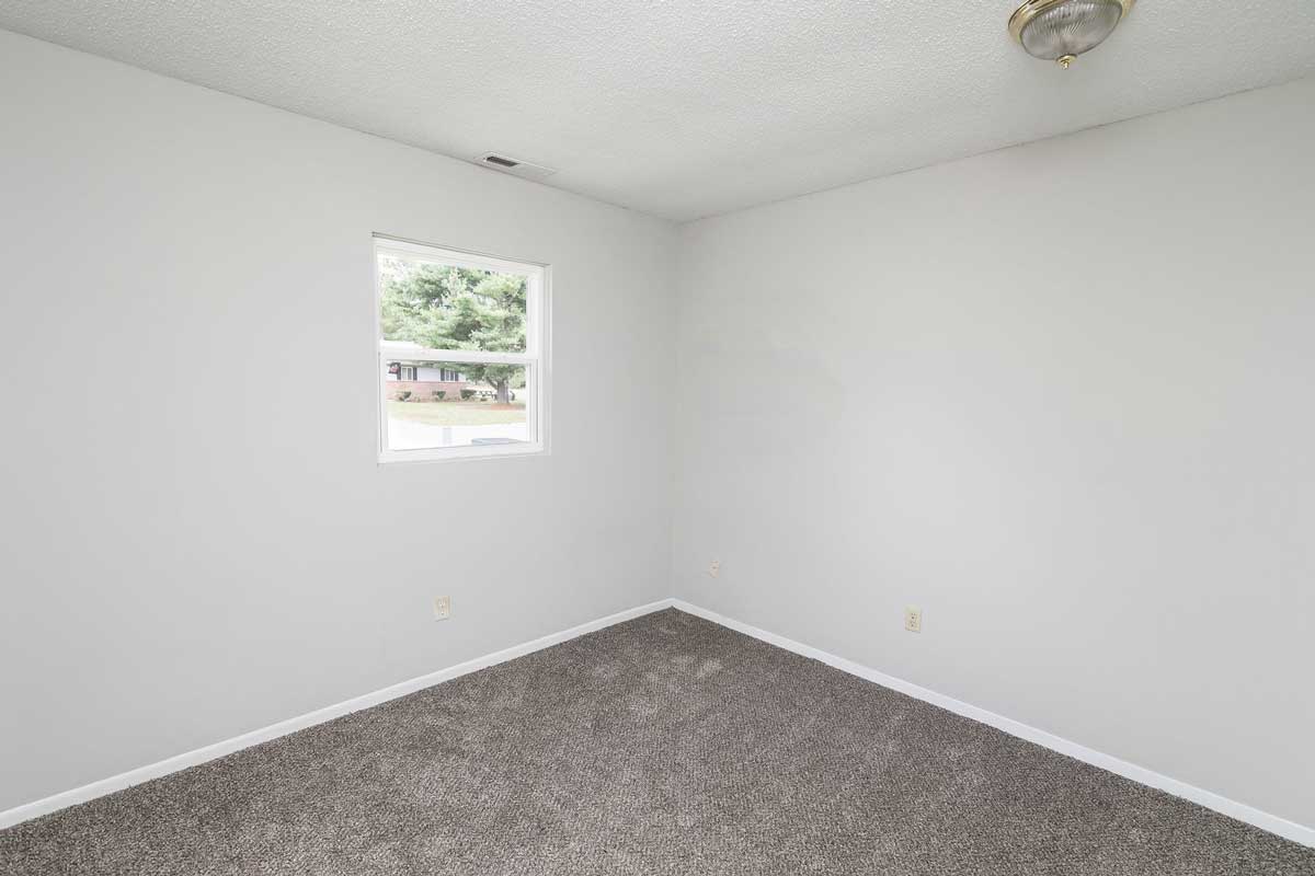 Township 2nd bedroom, view from doorway looking in, overhead light, and window